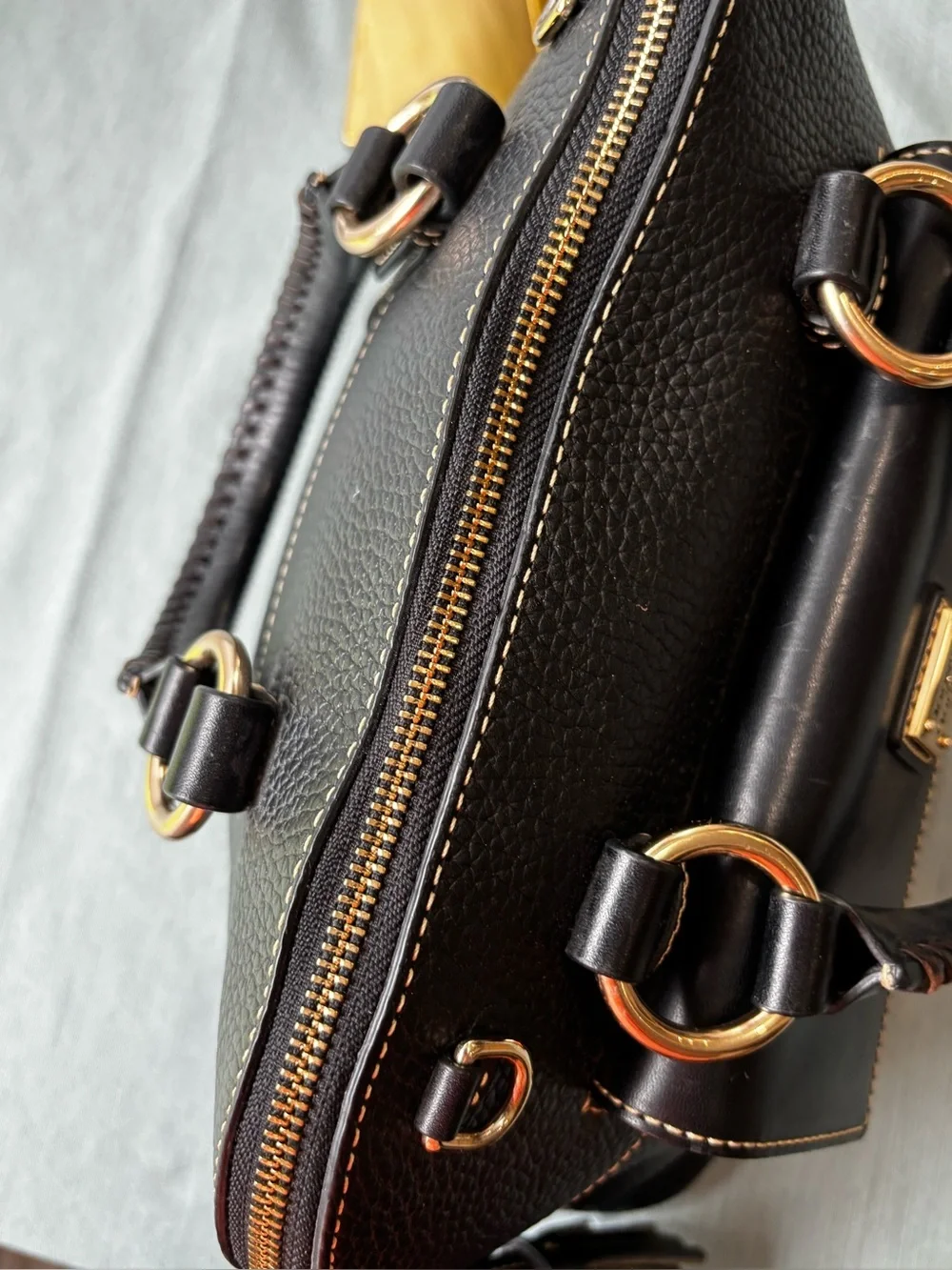 Dooney & Bourke Black Leather Satchel with Gold Hardware and Tassel